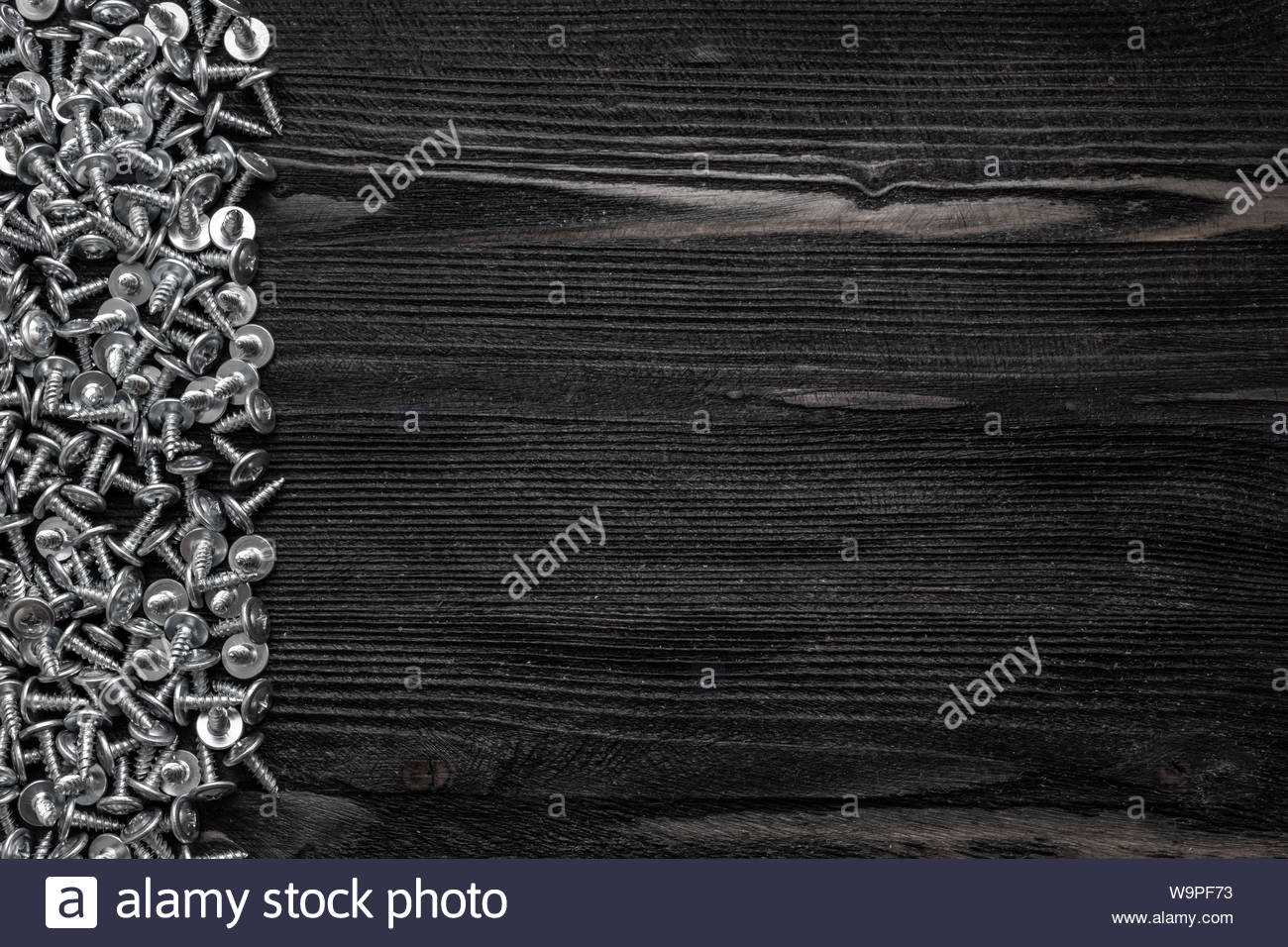 Some Wood Crews On Dark Wooden Desk Board Surface. Top View Within Borderless Certificate Templates